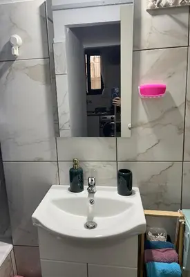 a bathroom with a white sink and a mirror at Chambres Élysées in Athens