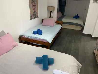 two beds in a room with blue towels on them at Chambres Élysées in Athens