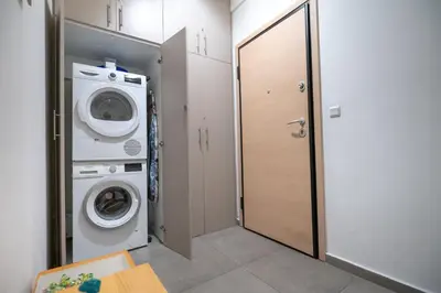 a laundry room with a washer and dryer at Central Athens Apt Patio View by MPS in Athens