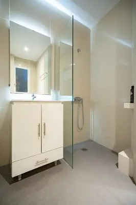 a bathroom with a glass shower and a sink at Central Athens Apt Patio View by MPS in Athens