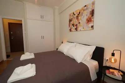 a bedroom with a bed with two towels on it at Neos Kosmos Studio For 2 by MPS in Athens