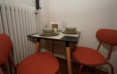 a table with two chairs and two plates and wine glasses at Neos Kosmos Studio For 2 by MPS in Athens