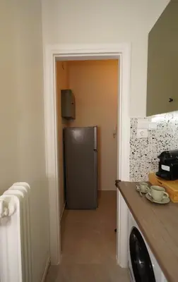 a kitchen with a stainless steel refrigerator in a room at Neos Kosmos Studio For 2 by MPS in Athens