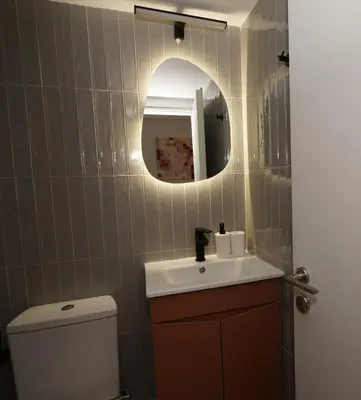 a bathroom with a sink and a mirror and a toilet at Neos Kosmos Studio For 2 by MPS in Athens
