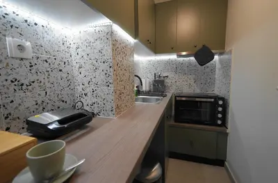 a small kitchen with a sink and a microwave at Neos Kosmos Studio For 2 by MPS in Athens