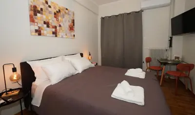 a bedroom with a bed with two towels on it at Neos Kosmos Studio For 2 by MPS in Athens