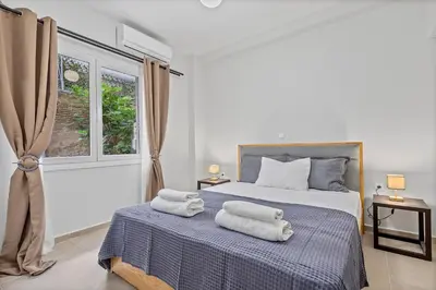 a bedroom with a bed with towels on it at Athens Urban Lifestyle Apartments in Athens