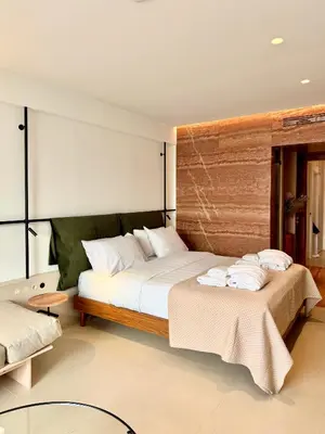 a bedroom with two beds with towels on them at Ermou 18 Private Jacuzzi Apartment in Athens