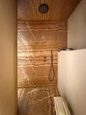 a shower in a room with a wooden wall at Ermou 18 Private Jacuzzi Apartment in Athens