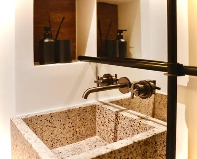 a sink in a bathroom with aaucet at Ermou 18 Private Jacuzzi Apartment in Athens