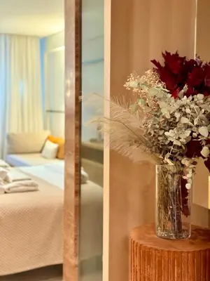 a vase of flowers on a table in a room at Ermou 18 Private Jacuzzi Apartment in Athens
