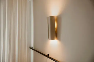 a light hanging on a wall next to a curtain at Ermou 18 Private Jacuzzi Apartment in Athens