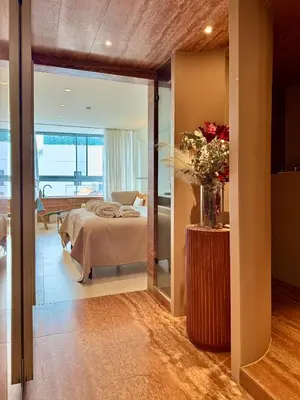 a room with a bed and a table with a vase of flowers at Ermou 18 Private Jacuzzi Apartment in Athens