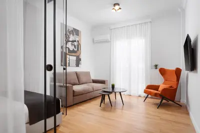 a living room with a couch and a chair at Acropolis Classy Apartments in Athens