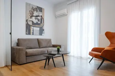 a living room with a couch and a table at Acropolis Classy Apartments in Athens