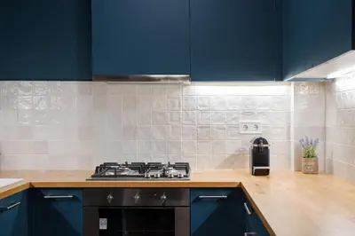 a kitchen with blue cabinets and a stove at Acropolis Classy Apartments in Athens