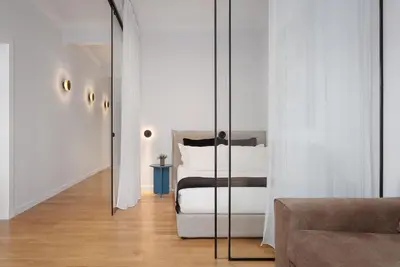 a bedroom with a bed and a glass wall at Acropolis Classy Apartments in Athens