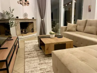 a living room with a couch and a coffee table at Thalassea - Athenian Riviera in Athens
