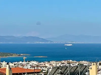 a view of a city with a ship in the water at Thalassea - Athenian Riviera in Athens