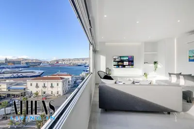 a living room with a view of the water at Endless Blue Breathtaking View Apt 7fl 2&4ppl in Piraeus
