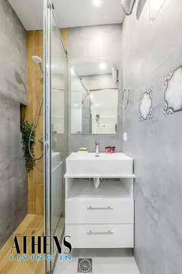 a bathroom with a white sink and a shower at Endless Blue Breathtaking View Apt 7fl 2&4ppl in Piraeus