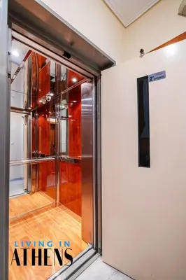 a sliding aluminium door in a room with a glass door in a building at Athenian Exclusive residence 4&2 ppl in Athens