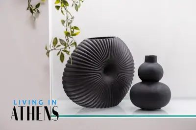 two black vases sitting on a shelf next to a vase at Athenian Exclusive residence 4&2 ppl in Athens