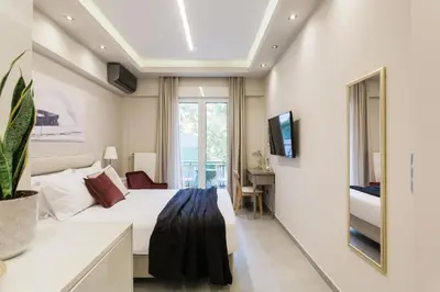 a hotel room with a bed and a television at Tranquil Studio in Pangrati Athens Center in Athens