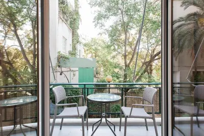 a balcony with chairs and a table and a table at Tranquil Studio in Pangrati Athens Center in Athens