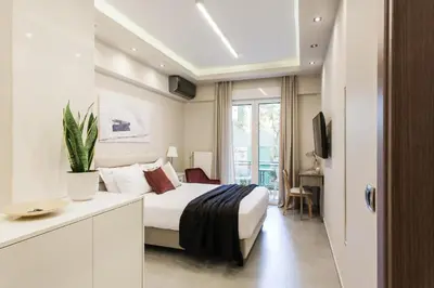 a hotel room with a bed and a window at Tranquil Studio in Pangrati Athens Center in Athens