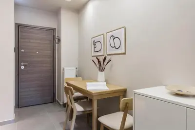 a kitchen with a wooden table and a table and chairs at Tranquil Studio in Pangrati Athens Center in Athens
