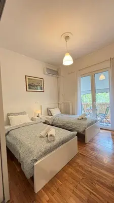 two beds in a room with a window at Fionas apartment in Athens in Athens
