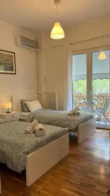 a bedroom with two beds with towels on them at Fionas apartment in Athens in Athens