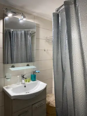 a bathroom with a sink and a shower curtain at Fionas apartment in Athens in Athens