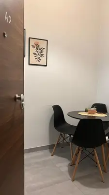 a room with a table and chairs next to a door at Fionas apartment in Athens in Athens