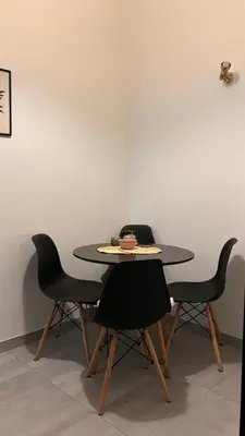 a table with four chairs and a plate on it at Fionas apartment in Athens in Athens