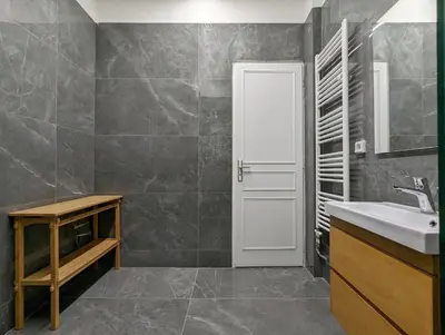 a bathroom with a sink and a white door at Casa Divas Grand Palace Apartments in Athens