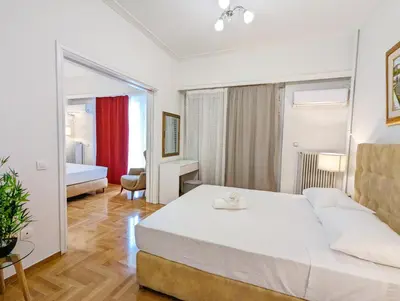a bedroom with a large white bed in a room at Casa Divas Grand Palace Apartments in Athens