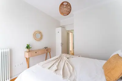 a bedroom with white walls and a bed at Rustic Whispers - close to Acropolis in Athens