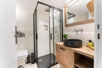 a bathroom with a sink and a shower at Rustic Whispers - close to Acropolis in Athens