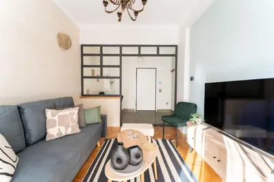 a living room with a couch and a table at Rustic Whispers - close to Acropolis in Athens