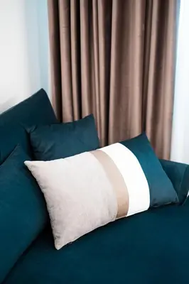 a pillow sitting on top of a blue couch at Kaplanon Residence Kolonaki in Athens