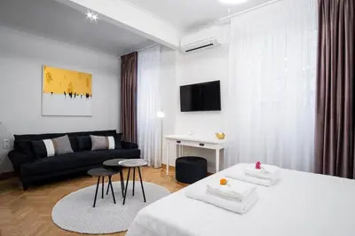 a living room with two beds and a couch at Kaplanon Residence Kolonaki in Athens
