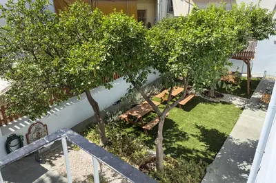 a garden with two trees and a bench at Callisto Elegant Apartment Near Acropolis in Athens