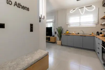 a kitchen with white cabinets and a counter top at Callisto Elegant Apartment Near Acropolis in Athens