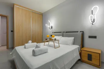a bedroom with a large white bed with two lamps at Callisto Elegant Apartment Near Acropolis in Athens