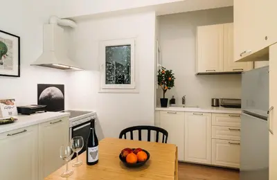a kitchen with a table with a bowl of fruit on it at Ideal escape for 2 in Athens