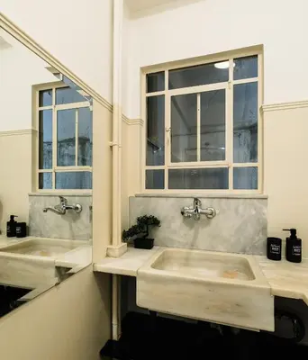two sinks in a bathroom with two windows at Ideal escape for 2 in Athens