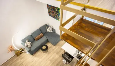 an overhead view of a living room with a blue couch at Loft 61 Charming renovated apartment with a loft! in Athens