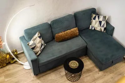 a green couch with pillows on it in a living room at Loft 61 Charming renovated apartment with a loft! in Athens